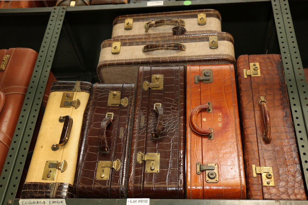 Seven assorted skin suitcases incl Mark Cross.: Largest Suitcase Dimensions: H 14" x W 22" x D 6"