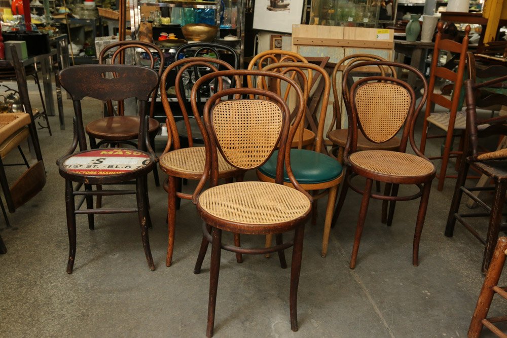 Nine bent wood side chairs three with caned: seats, one with leather seat, colors incl black, brown, blonde. Approx. Dimensions (caned-back chair): H 36" x W 18" x D 20"