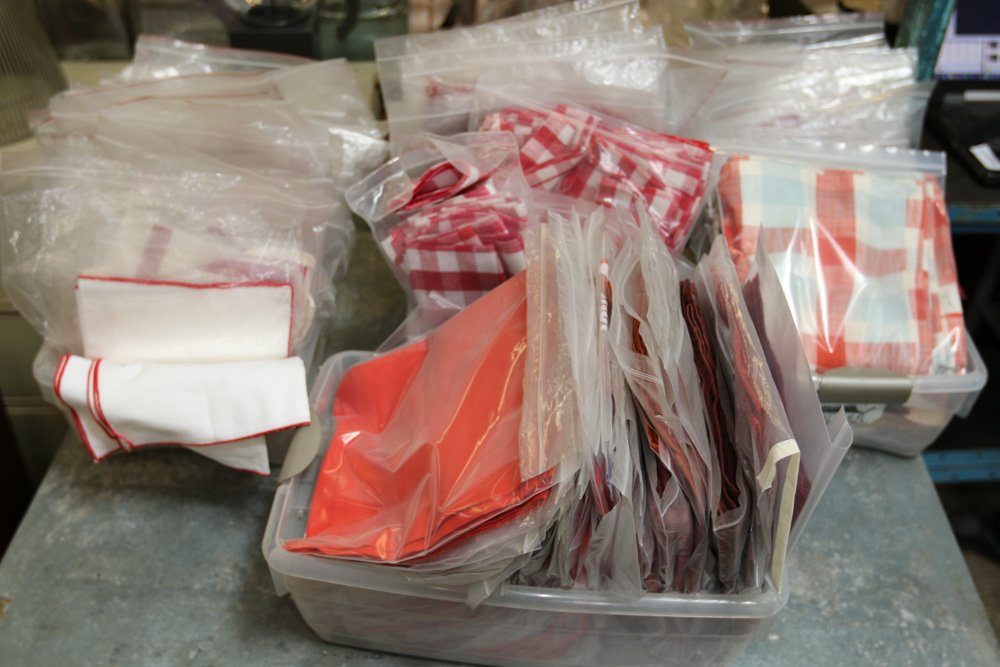 Grouping of red check napkins.: Approx. 100-150 sets (bags)