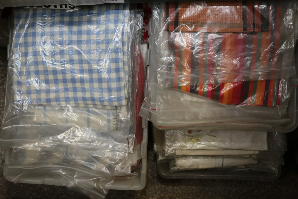 Four boxes of table cloths incl blue, white, red, (1 of 4)