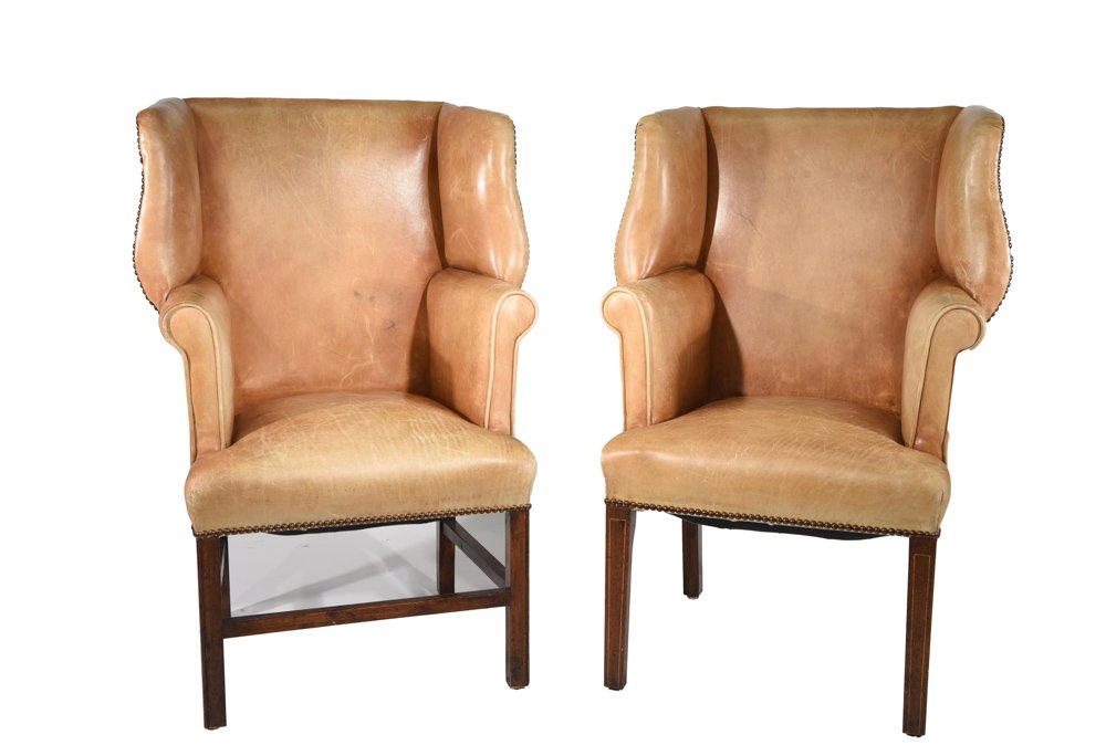PAIR OF PETITE LEATHER WING BACK CHAIRS: Small leather and brass tacks wingback. Dimensions: H 39.25" x W 19.5" x D 24.5" Condition: Light creasing, scuffs, and scratches to upholstery. Some nicks and dings to legs.
