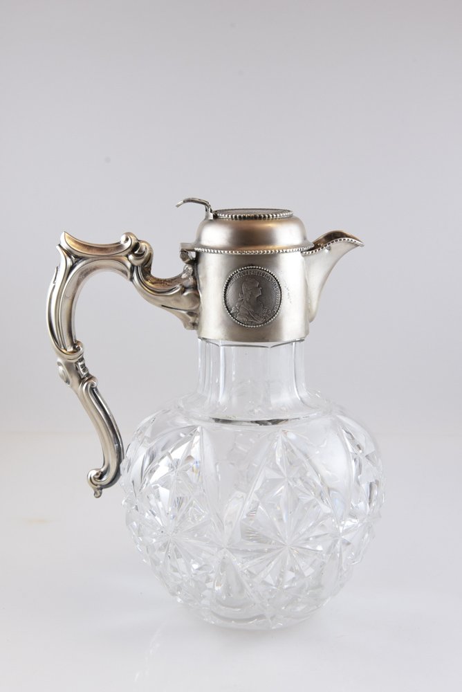 RUSSIAN SILVER AND CUT GLASS DECANTER W/ COINS: Hallmarked by Br. Grachev on the top lid, on the spout and sides near on of the coins. On the top of the lid a coin from 1833, 1 1/2 ruble piece commemorating The Battle of Borodino. Fought on Septemb