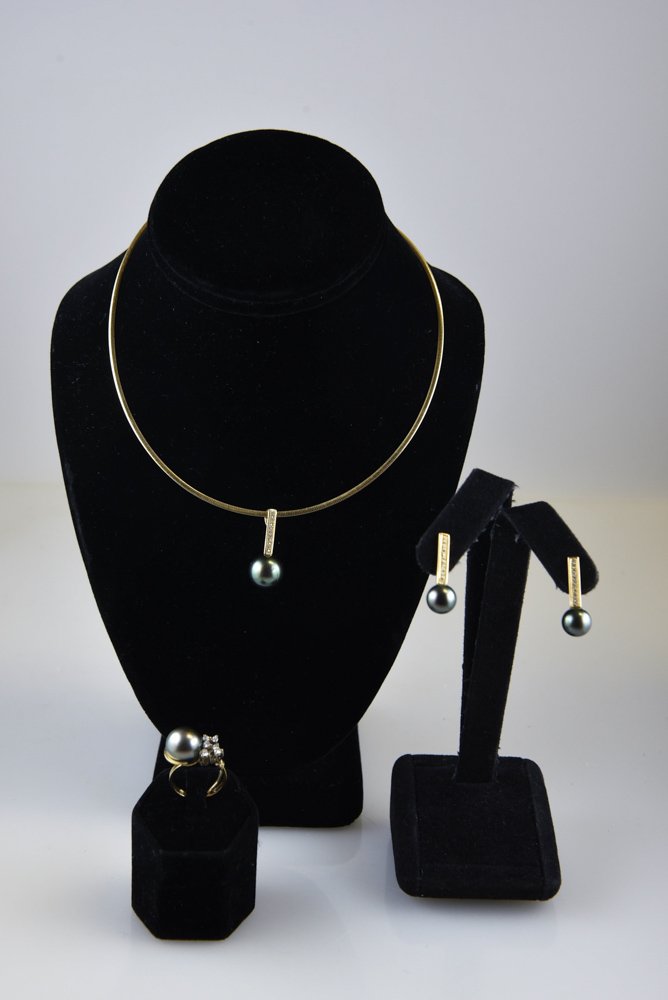 TAHITIAN PEARL & 18K GOLD JEWELRY SUITE: Including rings, earrings and necklace all with diamond accents Dimensions: The pearls are: Pendant: 12.5mm Ring: 12mm and earrings: 9mm Length: 16" Ring Size: 6