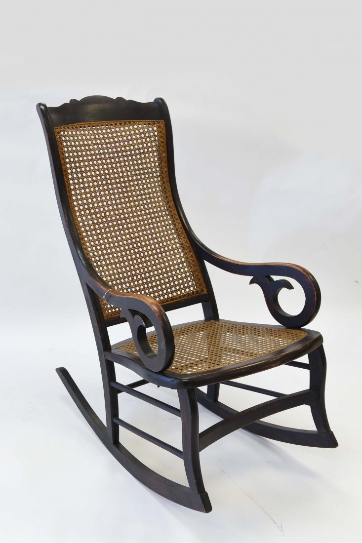 CANED SEAT ROCKING CHAIR: Dimensions: H 40" x W 23" x D 34" Condition: Chair shows normal wear throughout, appropriate with age and use; mostly to arm rests. No breaks to frame or caning.