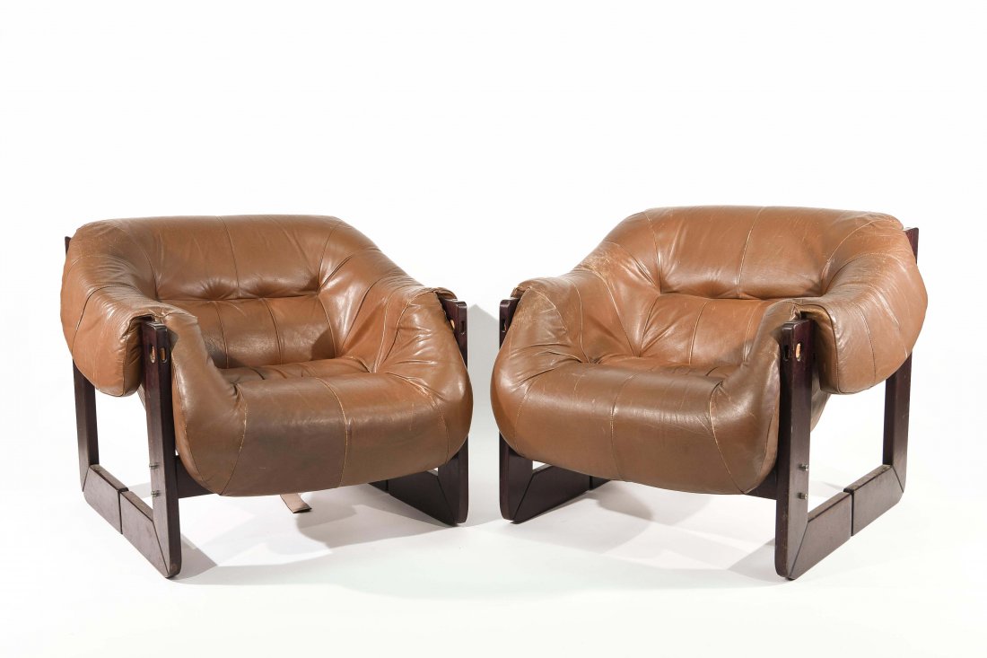 PAIR OF PERCIVAL LAFER ROSEWOOD LOUNGE CHAIRS: Dimensions: 28" x W 32" x D 33" Condition: Heavy creasing, some small paint marks, and scuffs to wooden base. Both chairs have a broken strap on the backside.