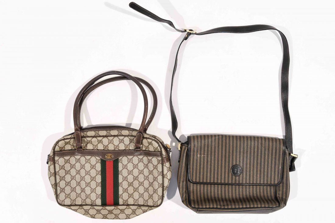 GUCCI AND FENDI HANDBAGS: 1 Fendi, 1 Gucci Dimensions: H 7" x W 12" (Gucci), H 8" x W 10" (Fendi); Condition: A few small stains to the liner of the Gucci bag, A few surface scuffs to the Fendi bag.
