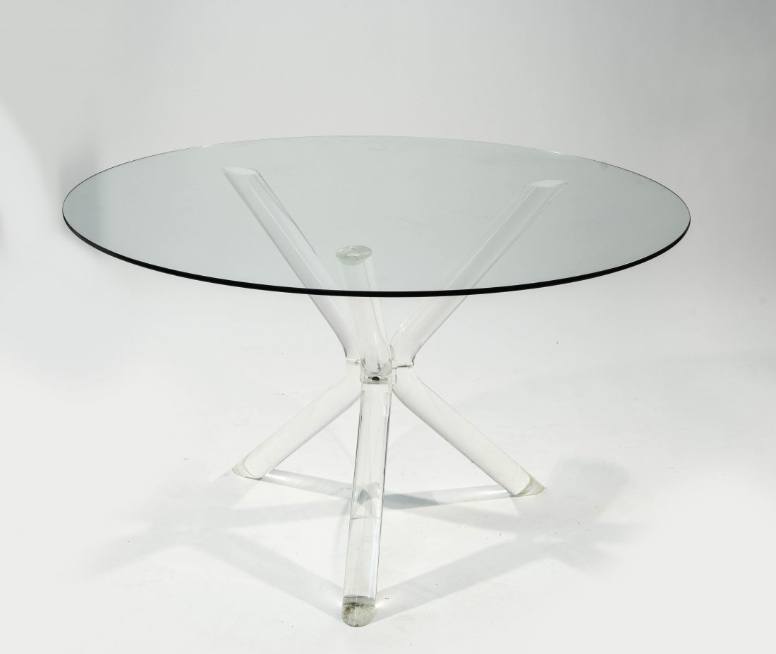 LUCITE AND GLASS TABLE IN THE STYLE OF CHARLES: HOLLIS JONES, saber leg. Dimensions: H 28.5" x Dia 48" Condition: Lucite is clear, minor scuffs to lucite, very light scratches to glass.