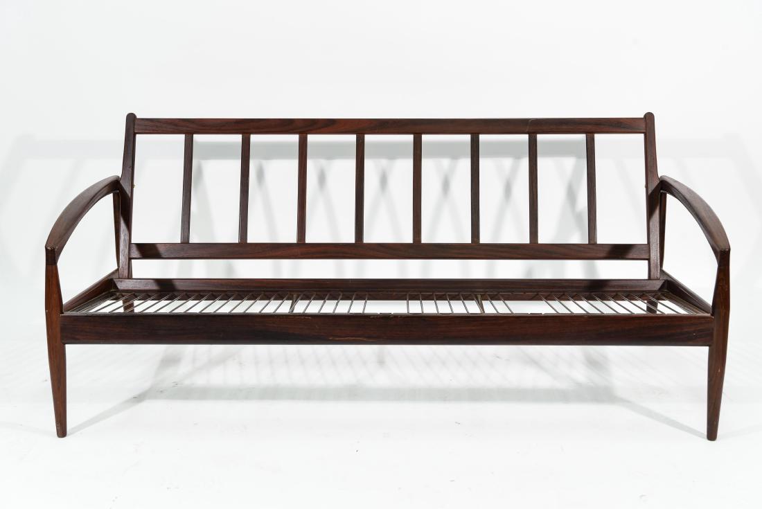 KAI KRISTIANSEN; MAGNUS OLESEN ROSEWOOD SOFA: Tag on underside. frame only no cushions Dimensions: H 28" x W 69.5" x D 28" Condition: Missing cushions. Couple nicks, dings, and white paint marks. Chip to front leg. Missing two seat springs. Light
