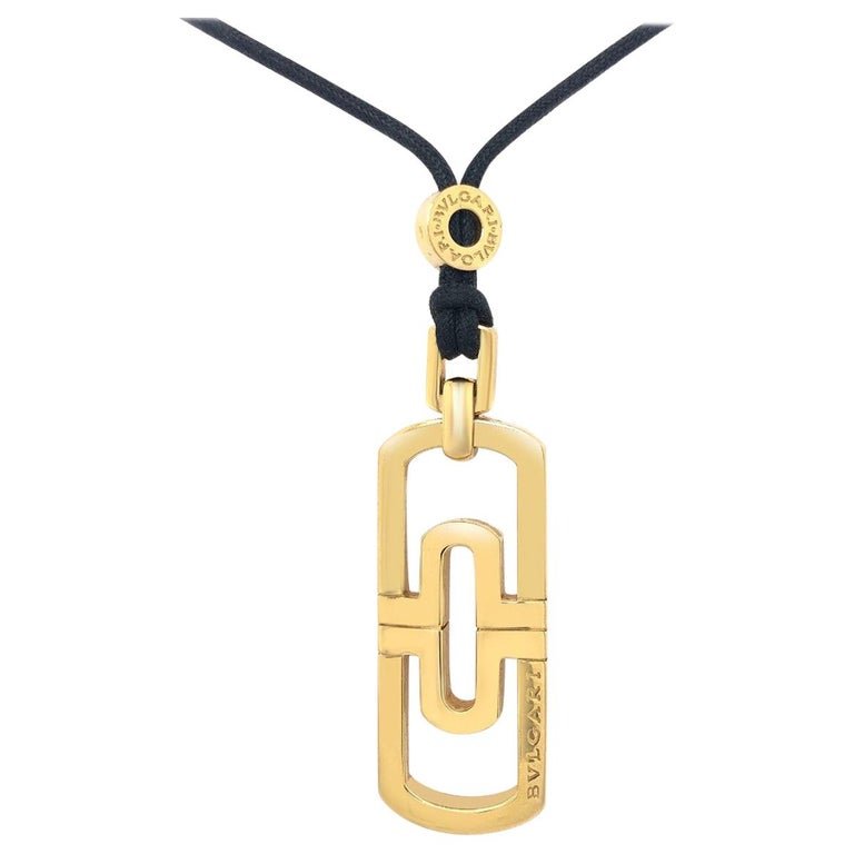 Bvlgari 18K YG Pendant with Original Black Necklace: Bvlgari 18 Karat Yellow Gold Pendant with Original Black Cord NecklaceDesigner: BvlgariMaterial: 18k Yellow GoldYear of Manufacture: Circa 1980sCondition: ExcellentTotal Weight: 27.7 gramsLength: 14.3