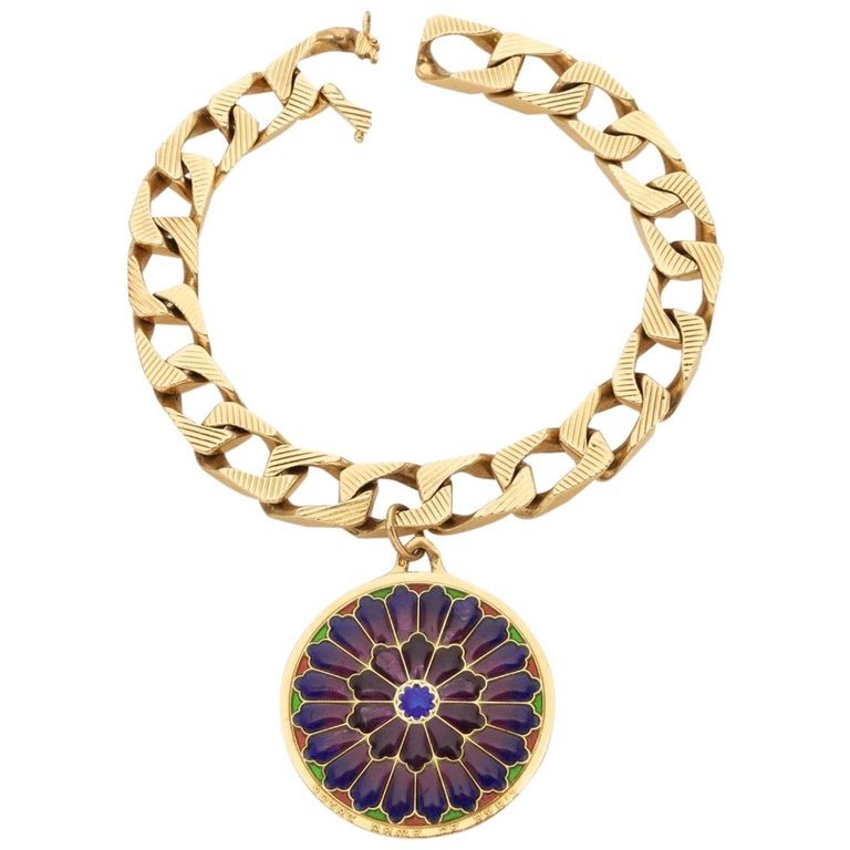 Bulgari 18 Karat Gold Vitrum Pastae Bracelet: The bracelet designed as a flattened curb link chain suspending a polychrome virtue pastae circular pendant with the inscription \'Notre Dame de Paris\'