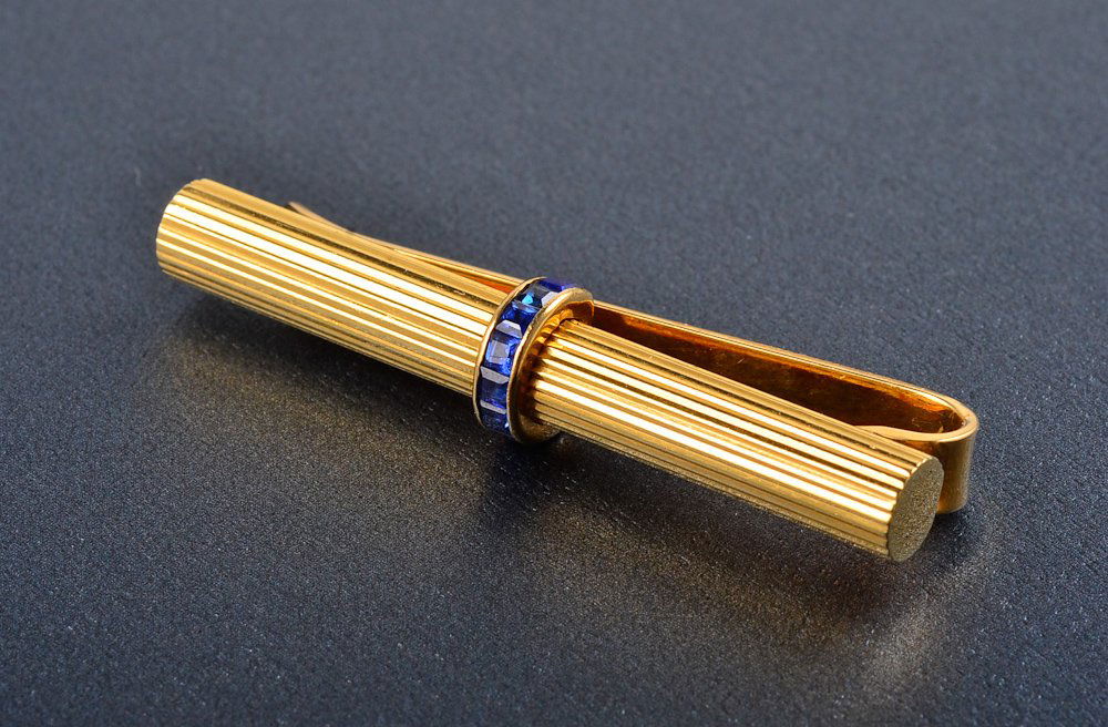 Van Cleef and Arpel tie clip: 14K with 8 sapphires Signed: VCA 19V2-54 Dimension: 1 3/4" long Gross weight: 5.6 dwt