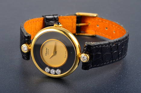 Chopard diamond gold lady's wristwatch: Chopard "Happy diamond" style with 3 floating diamond in watch and flanked with 2 diamonds. leather band. Dimension: 1" diameter.