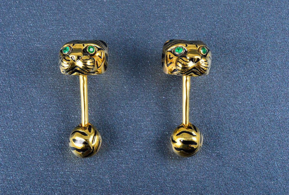 David Webb tiger cuff-link: David Webb tiger enamel gold cuff-link. black enamel and green emerald eyes. Dimension: 1 1/4" long Gross weight: 14.8 dwt