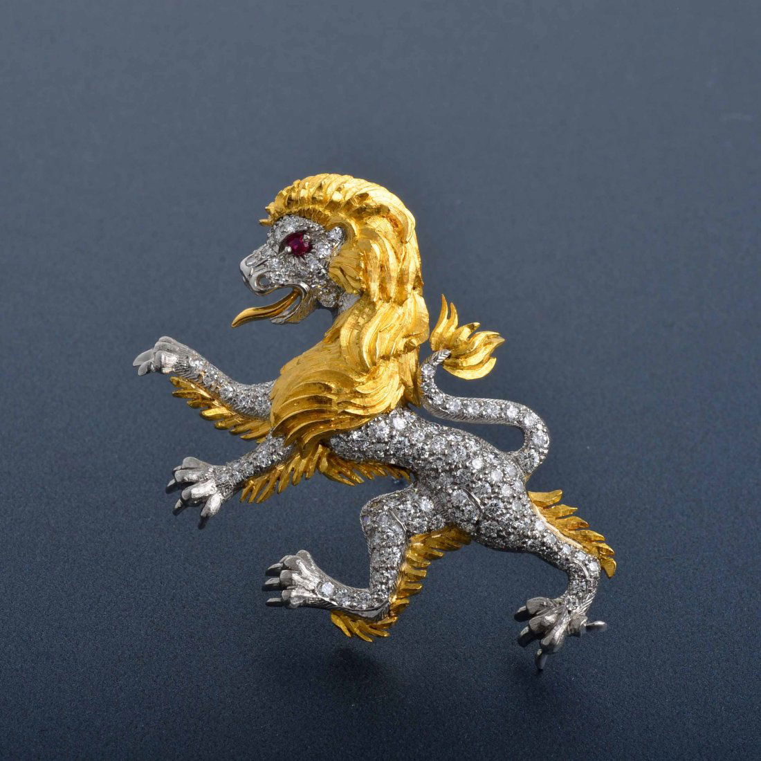 McTeigue Platinum and Gold Diamond Dragon Brooch: McTeigue 18k yellow gold and platinum dragon brooch. The 18k carved yellow gold wraps the head of the dragon as well as adorns the legs and tail. The platinum body and tail of the dragon are glittered