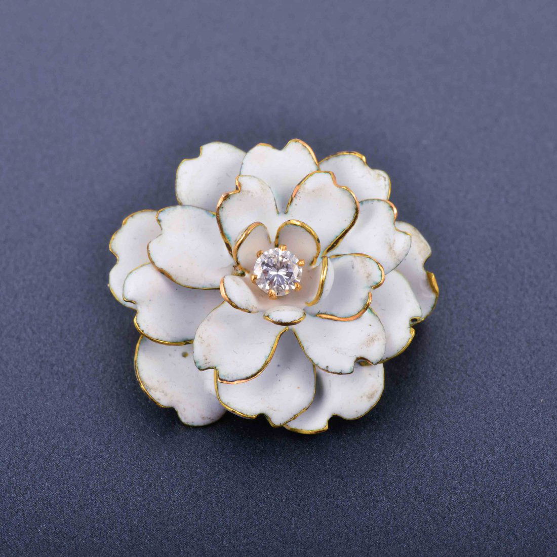 White Enamel Gold Flower Pin: White Enamel Gold Flower Pin one diamond weight approx. .20 ct Measure 1 1/4" x 1" Weight 7.7 dwt