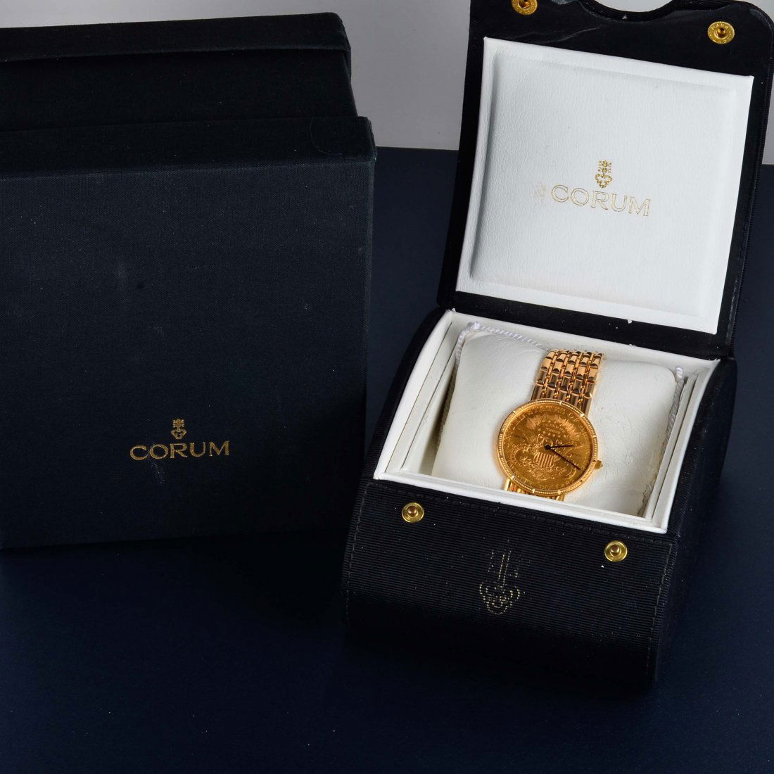 Corum Gold Coin Face Wristwatch: Corum $20 U.S. gold coin face men's wristwatch. Band is 18k yellow gold and face is 24k yellow gold. One diamond on watch winder. Signed Corum, 750, gold stamp Face measures 2" x 1 5/8" Weight 89.9 dw