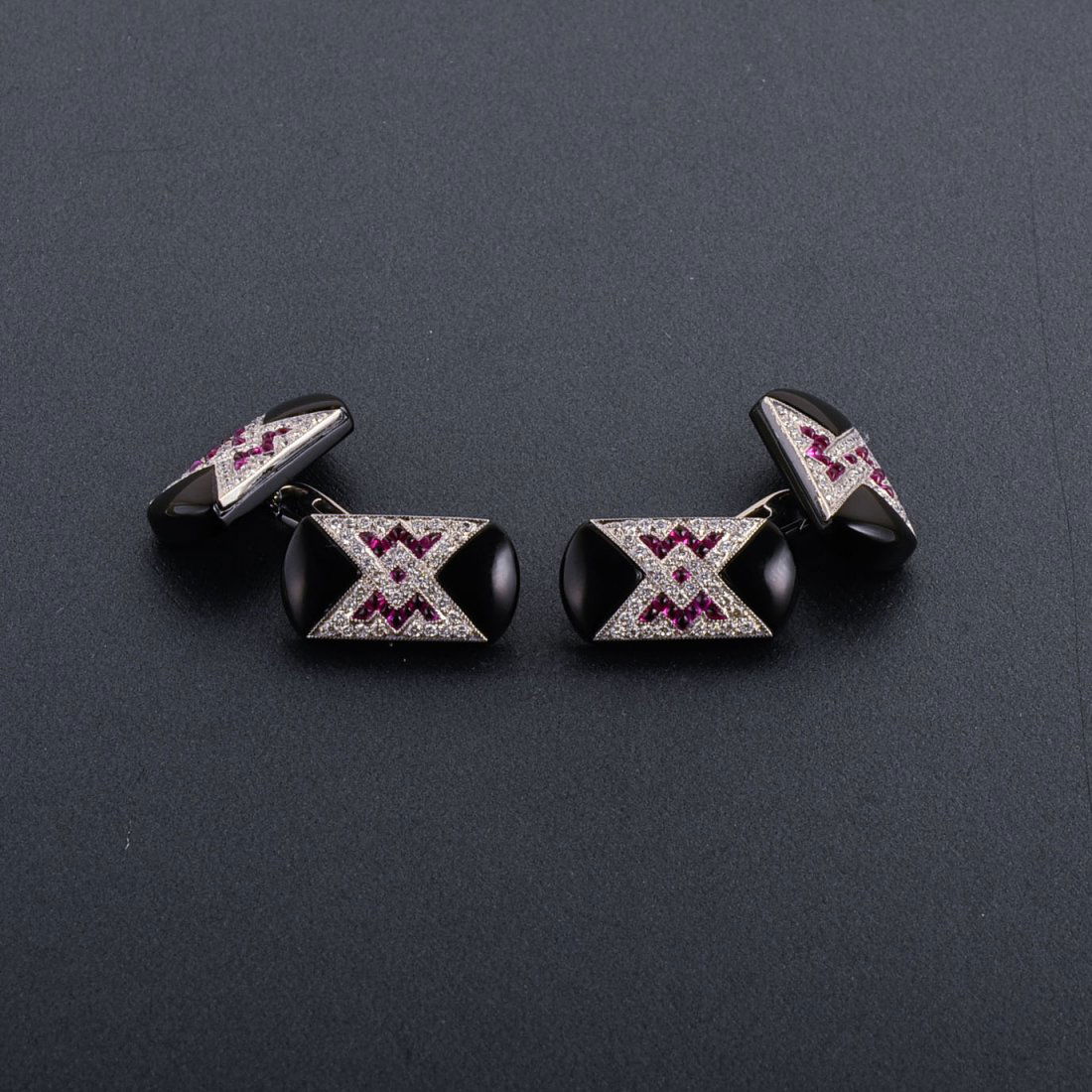 A Pair of 18K Retro Diamond, Ruby and Onyx Cufflin: One pair of 18k white gold retro diamond, ruby and onyx cufflinks Stamped 18K 30 cabochon rubies weigh approx .90 ct 144 round cut diamonds weigh approx 1.44 ct Measure 3/4" x 1/2" Weight 7.8 dwt