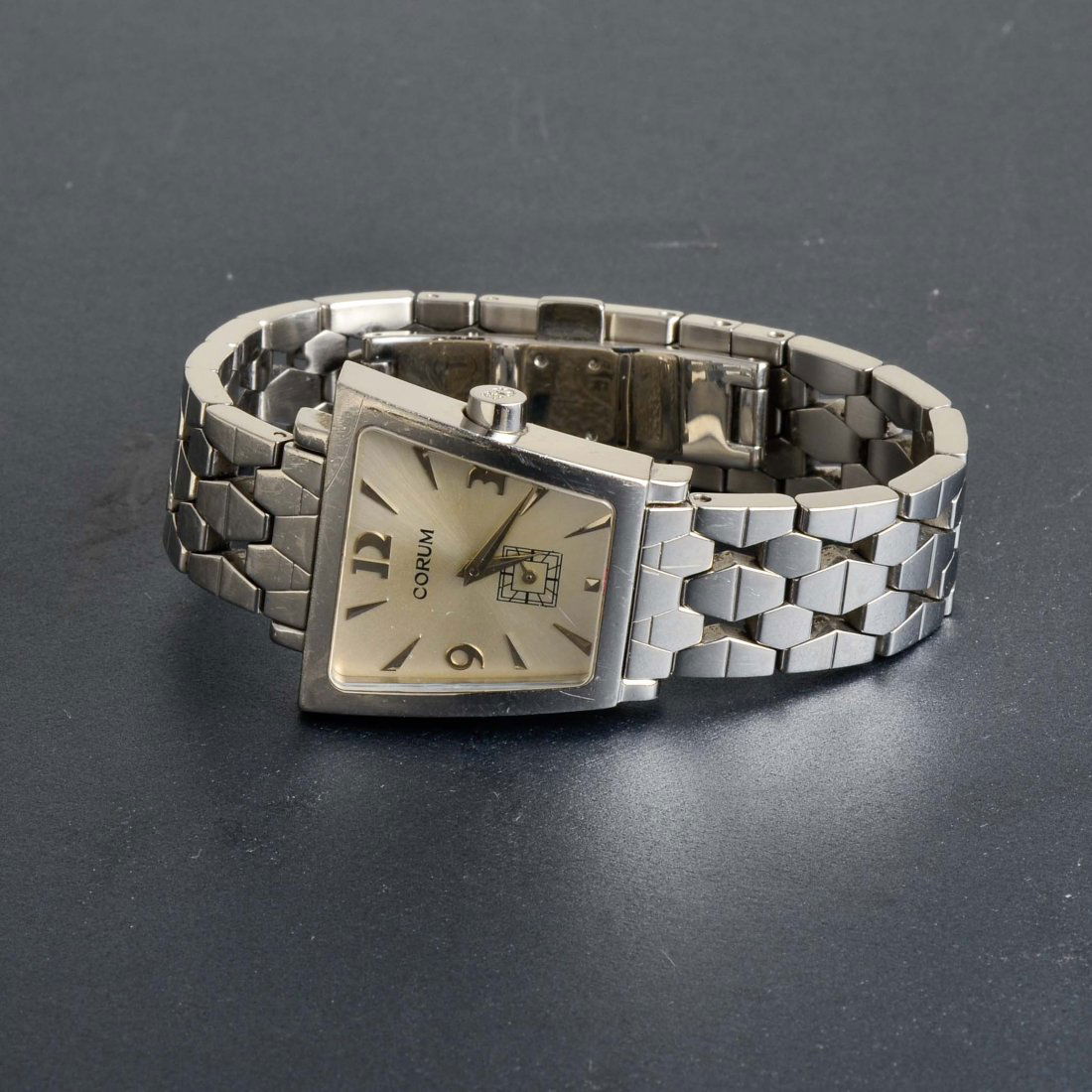 Corum Trapeze Woman's Stainless Steel Watch: A woman's Corum Trapeze stainless steel watch, with Swiss made quartz movements. The face is signed with Corum's logo, model # 105.404.20 and Serial # 1702625 on the back. The watch face is 1" x 1". T