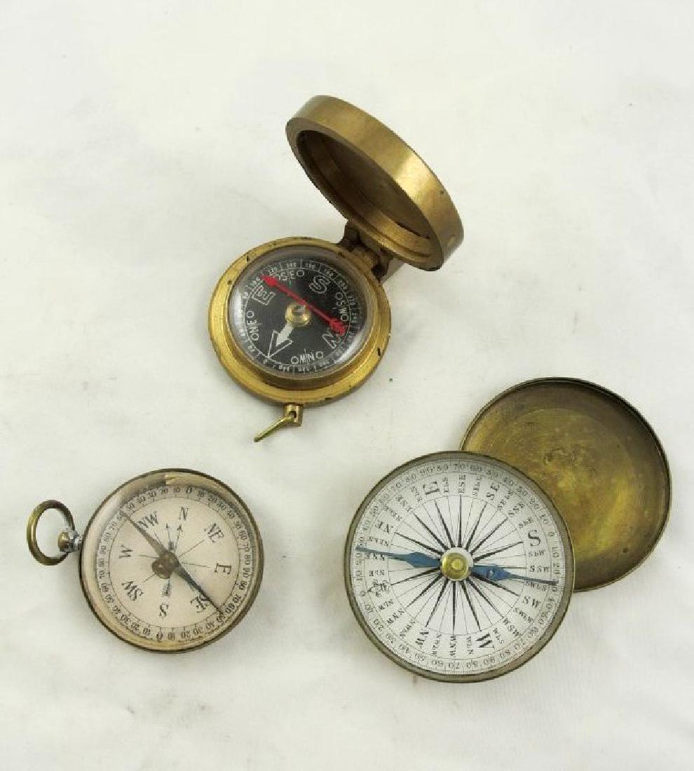 Three Collectible Antique Compasses: Group of three antique and vintage compasses, two having closed faces, the third being open-faced. Largest 2 1/4 inches.