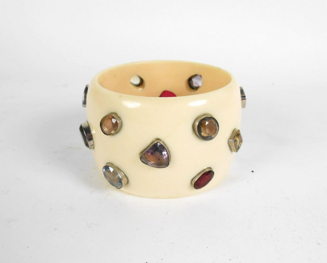 1940's Bracelet With Semi-Precious Stones: Vintage 1930-1940 celluloid fashion bracelet set with numerous semi-precious stones. Width of bracelet is 3 1/2 inches. Opening is 2 1/2 inches. Very good condition.