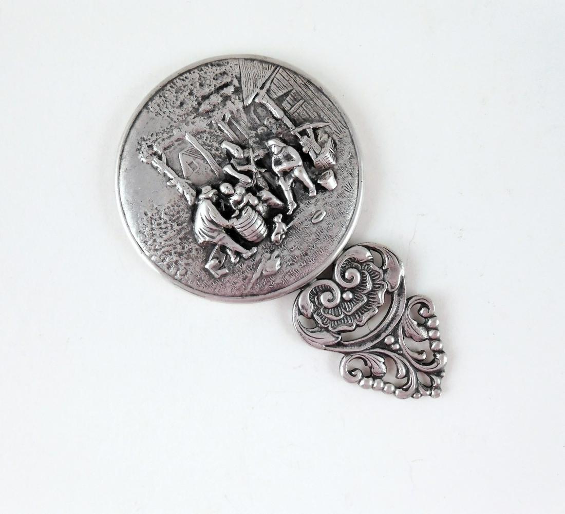 Vintage Hans Jensen Pocket Mirror: Vintage Hans Jensen (Denmark) pocket mirror. Silverplated. Back of mirror has a depiction of a Dutch town market scene, and the handle has a flower with trailing scroll work on it. Marked "DENMARK" on