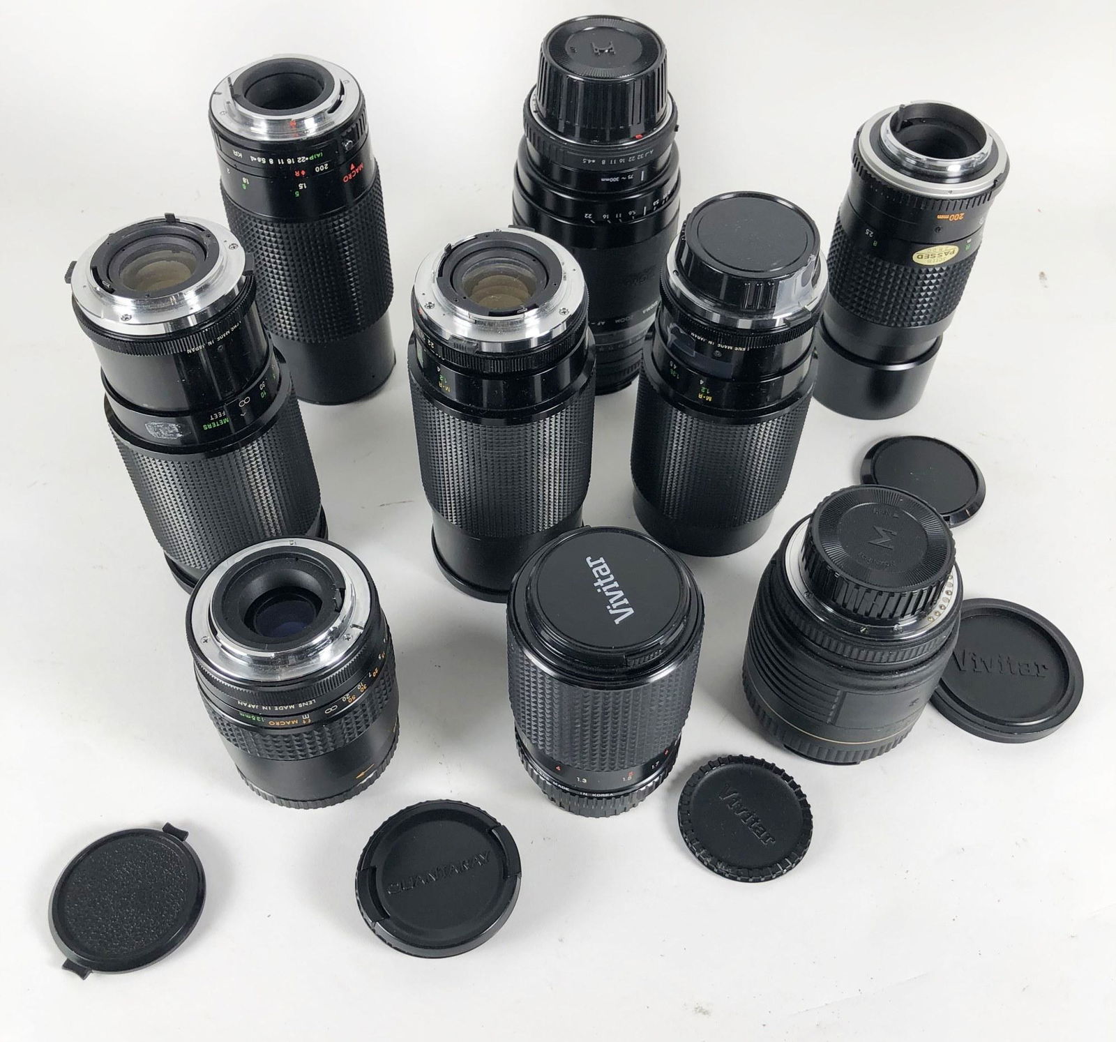 Group Of 9 Camera Lenses: Group of nine camera lenses, including Vivitar, Minolta, Nikon, zoom lenses, etc. Lenses appear to be in very good condition.