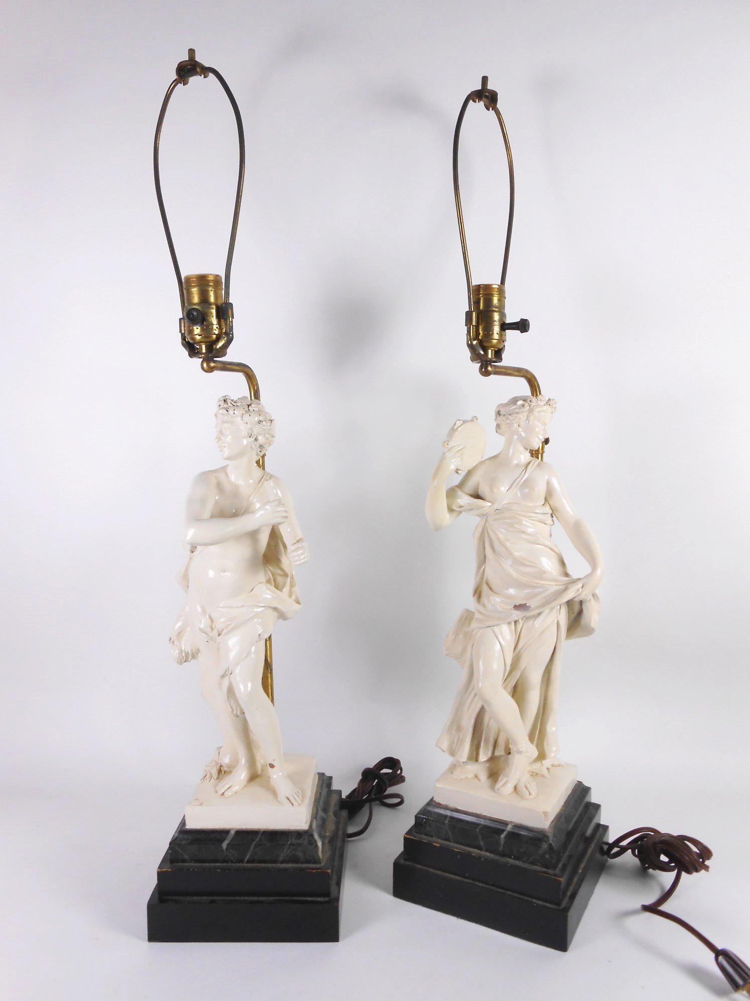 Pair Lamps, Classical Figures: Pair white-painted metal figures, Classical maidens, having marble bases raised on conforming stepped plinths, later fitted as lamps. French, circa 1900-20. H. (overall) 28 inches. Height of each figu