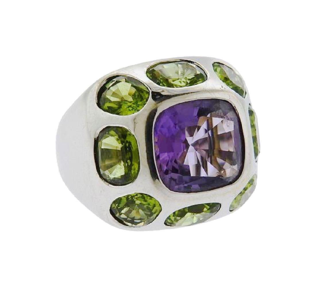 18 KT Gold Fashion Ring With Gemstones: 18 KT gold fashion ring set with a central amethyst and 8 surrounding peridots. Ring size 6. Gemstones have not been graded. Wt. 18.1 grams