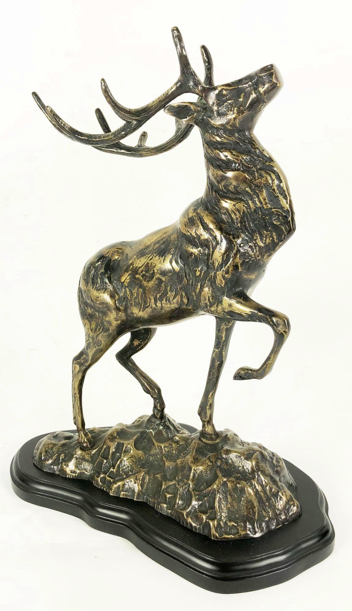 Cast Metal Figure Of A Stag: Cast metal figure of a stag on conforming ebonized wood base, unsigned. Circa mid-20th century. H. 12 1/2 inches.