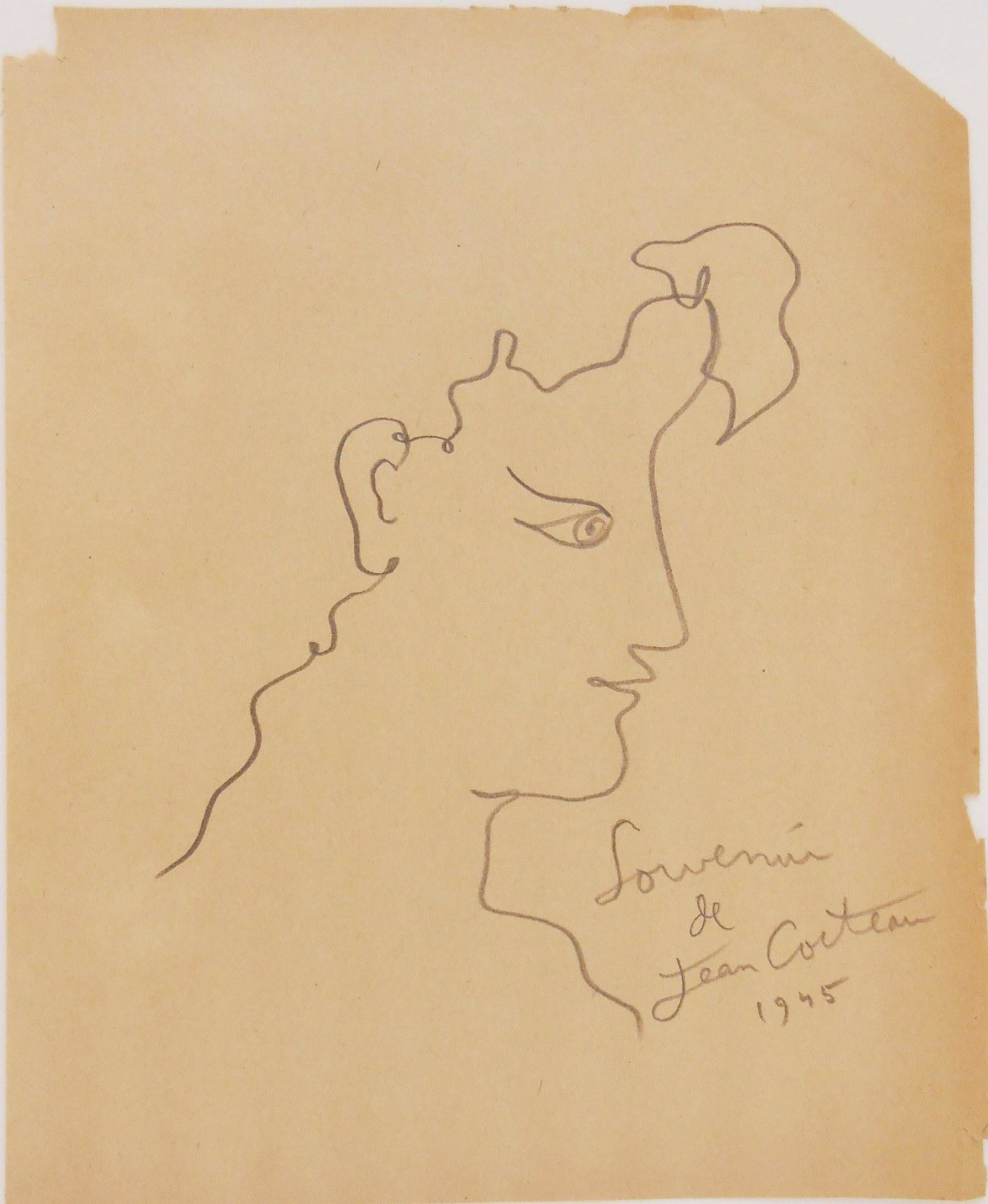 Jean Cocteau (1889-1963) Graphite Sketch: Graphite drawing on light brown wove paper, face in profile, signed* (Jean Cocteau, 1889-1963). Also inscribed and dated 1945. 8 7/8 x 7 1/4 inches. Some small margin tears and minimal paper losses, o