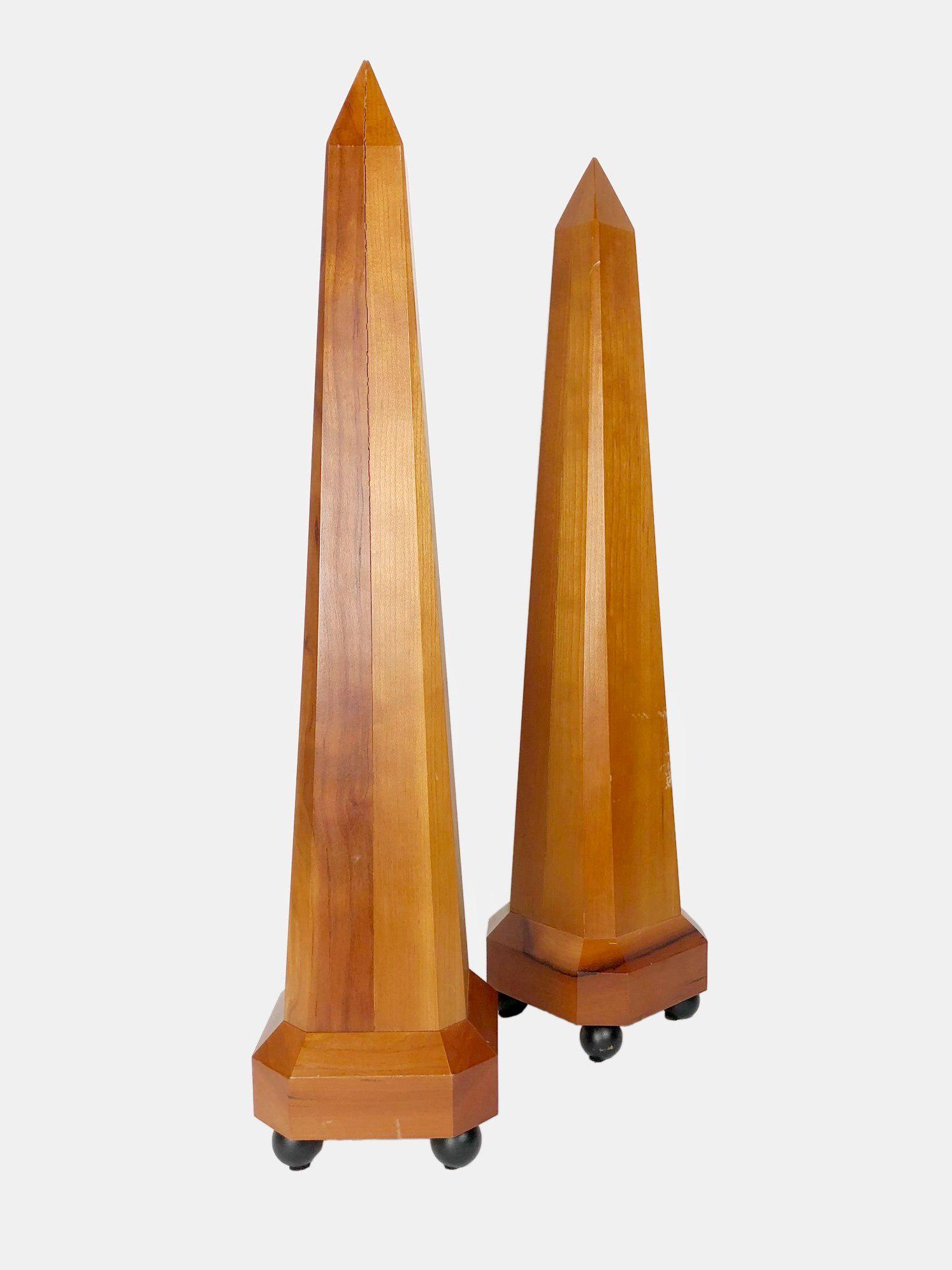 Pair Of Wooden Obelisks, 20th Century: Nice pair of wooden obelisks, each raised on ebonized ball feet, circa mid-20th century. Very good condition. H. 21 1/2 inches. W. 5 inches.