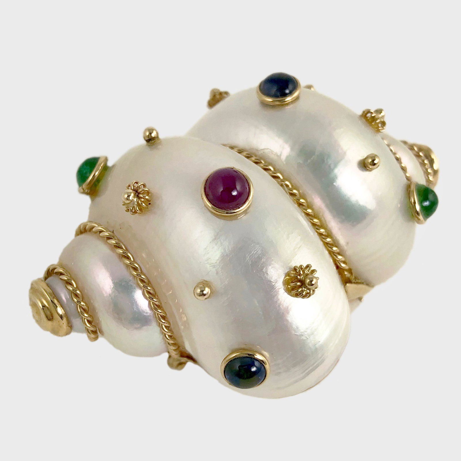 14K Gold, Shell, & Gem-Set Brooch, By Maz: Gem-set shell brooch in 14K yellow gold by Maz, containing two each round cabochon rubies, sapphires and emeralds. Stamped and signed. 63 x 40 mm. 28 grams. Provenance: Property from a prominent Dalla