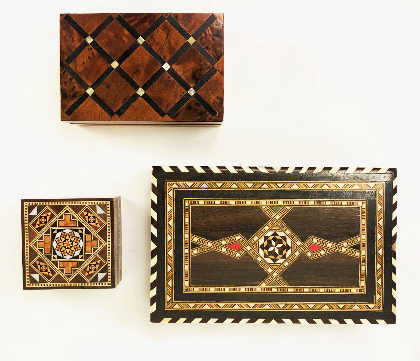 Three Inlaid Boxes, 20th Century: Group of three finely inlaid trinket boxes, one with mother-of-pearl, probably Syrian or Middle Eastern, circa mid-20th century. All in very good condition. Largest measures 8 3/4 x 5 1/2 inches. Smal