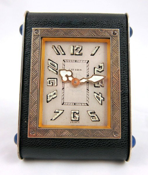 Cartier Bedside Clock: Elegant vintage Cartier table clock of Art Deco design, composed of sterling silver, brass, gold, and leather, with lapis lazuli accents. Luminous hands.