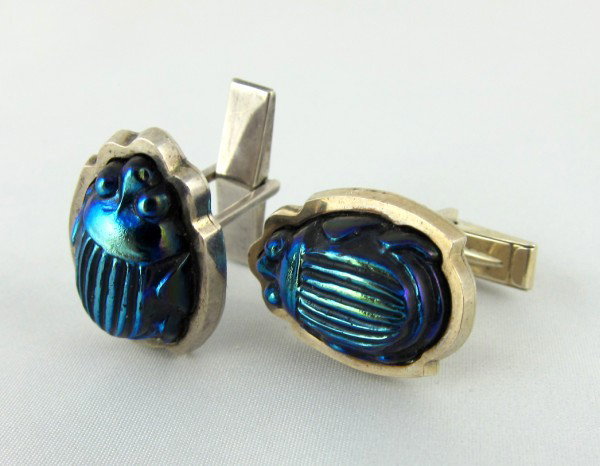 Pair Of Tiffany & Co. Scarab Cufflinks: Tiffany & Co. sterling silver cufflinks set with vintage Tiffany glass scarabs, circa 1910. Very interesting and collectible. A gift to the present owner by Gene Moore. Gene Moore (1910-1998) was vice