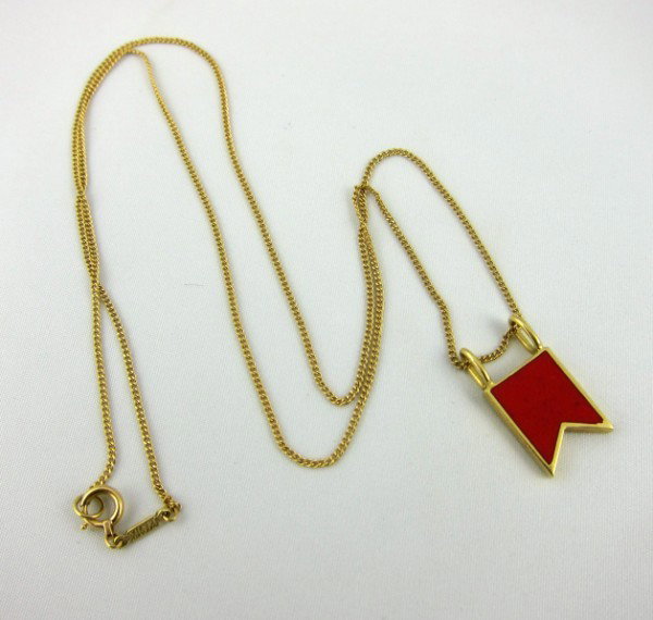 Tiffany & Co. 18KT Flag and Chain: Tiffany & Co. 18KT and red enamel nautical flag on 18KT gold chain (18 inches). Stamped Tiffany & Co./Ralph Lauren/750. Circa 1980's. A very collectible and rarely available piece of jewelry. A gift t