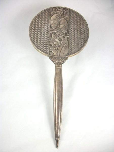 Sterling Silver Art Deco Hand Mirror: Unusual "Mayan" design Art Deco hand mirror, sterling silver, circa 1930. L. 14 1/2 inches. Very good condition.