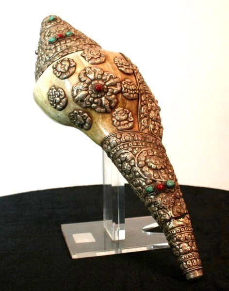 Tibetan Silver-Clad Seashell: Inset with various precious stones. L. 14 inches. Probably circa early 20th century.