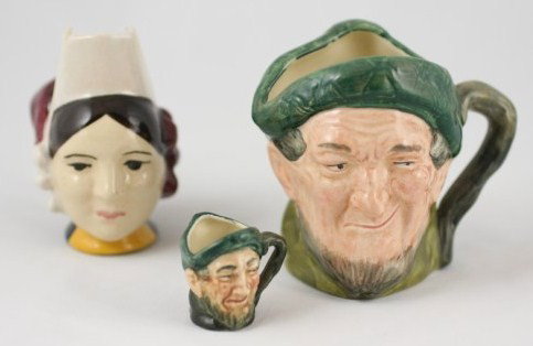 Group Of Three Vintage Ceramic Mugs: One Quimper, two Royal Doulton toby mugs. Circa early 20th century. Height of largest: 3 3/4 inches. Good condition.
