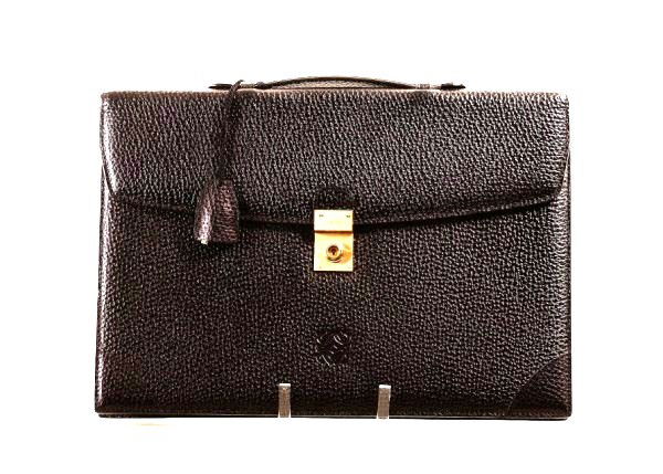 Loewe Briefcase: Beautiful embossed and stamped leather attache with key by Loewe. 15 1/2 x 10 3/4 inches. Stamped MADRID. Briefcases by Loewe frequently retail over $1,000. Very good condition.