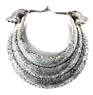 Silver-Clad Neck Collar, Mongolian: Silver and white metal Mongolian neck collar, having an intricate foliate design with fish motif supports. Length approximately 9 inches.
