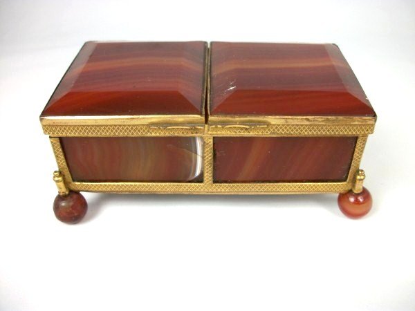 Antique Agate And Gilt-Metal Trinket Box: Unusual compartmented agate and gilt metal trinket box on ball feet, probably European, circa late 19th century. L. 4 1/4 inches. W. 2 1/4 inches. H. 1 3/4 inches. Condition Note: One of the panels is