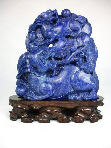 Chinese Lapis Carving: Well-executed lapis carving, on wood stand. Qing Dynasty. H. 8 inches. W. 6 1/2 inches. Very good condition.Important Notice To Bidders: Chinese ceramics and other Asian art forms, have been copied fr