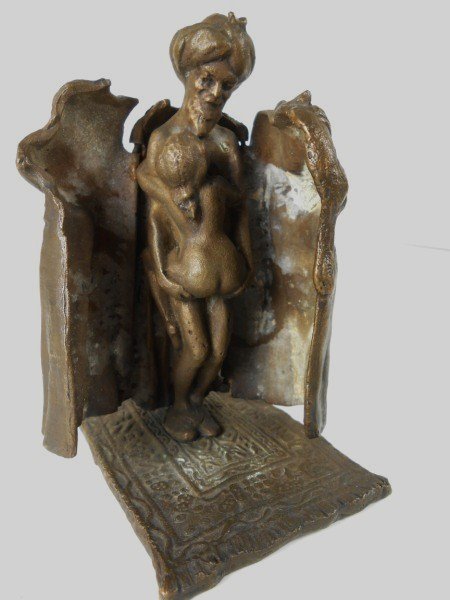 Tiffany Studios Rare Erotic Bronze Figure: Rare bronze figure of a sultan with cat, his robes opening to reveal a female in a sexual position. Resting on a "Persian carpet" base. Stamped Tiffany Studios, New York. Probably circa 1900. H. 4 1/2
