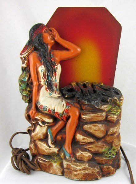 Art Deco Indian Maiden Table Lamp: Vintage lamp features an Indian maiden sitting by a fire (wheel rotates behind glass to imitate flames). Probably circa 1930-40. H. 12 inches.