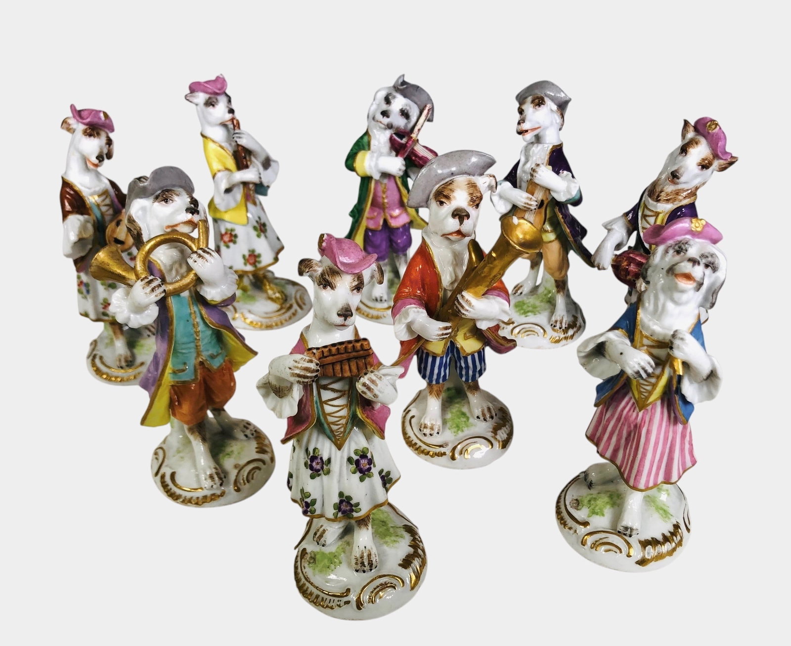 Meissen Porcelain Dog Band: Nine-piece porcelain dog band by Meissen, 20th century. Underglaze crossed swords. Three figures with slight damage (see photographs), otherwise very good condition. Height of tallest figure is approx