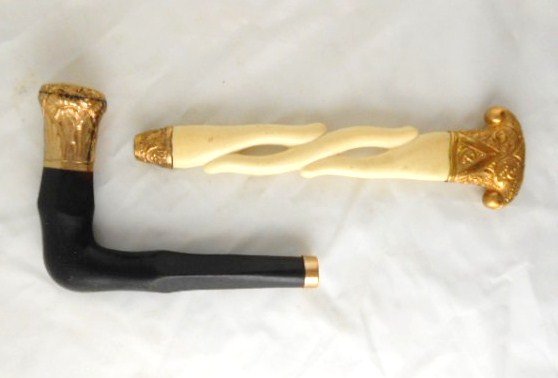 Two Antique Umbrella Handles: One nicely engraved ebony and gilt-metal handle, one ivory and engraved gilt-metal handle. Circa late 19th century. The longest measures approximately 8 1/2 inches.