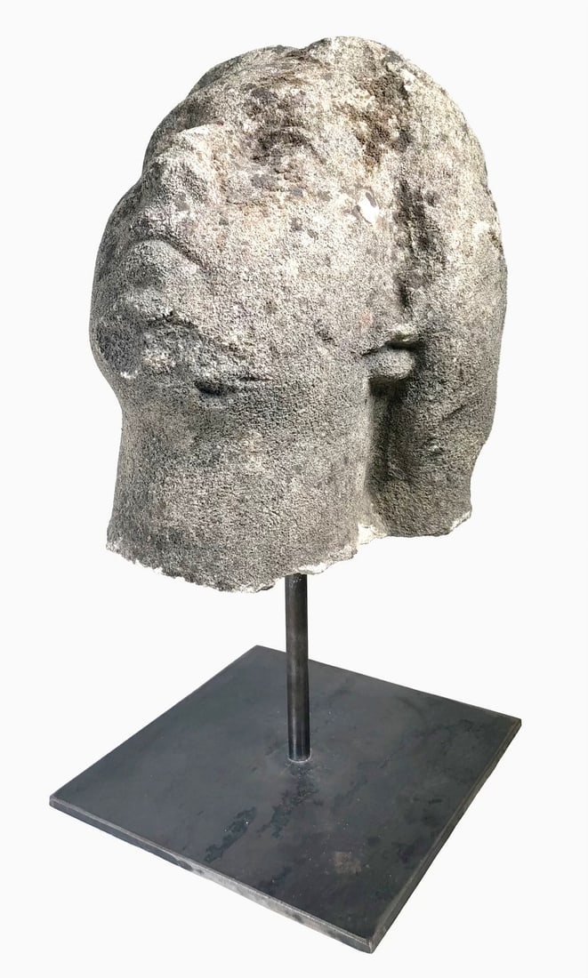 Carved Stone Head, 17th Century: Carved stone head in the Roman or Greek style, possibly 17th century or earlier. Good condition overall; wear commensurate with age and exposure to elements. Dimensions: H. (with stand) 16 inches Dime