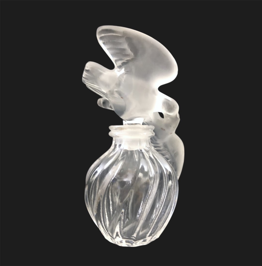 Lalique L'Air Du Temps Perfume Bottle: Lalique swirl-form "L'Air Du Temps" perfume bottle with frosted bird stopper. Signed, circa late 20th century. Very good condition. No chips or damage noted.Dimensions: H. 4 1/4 inches Dia. 3 inches