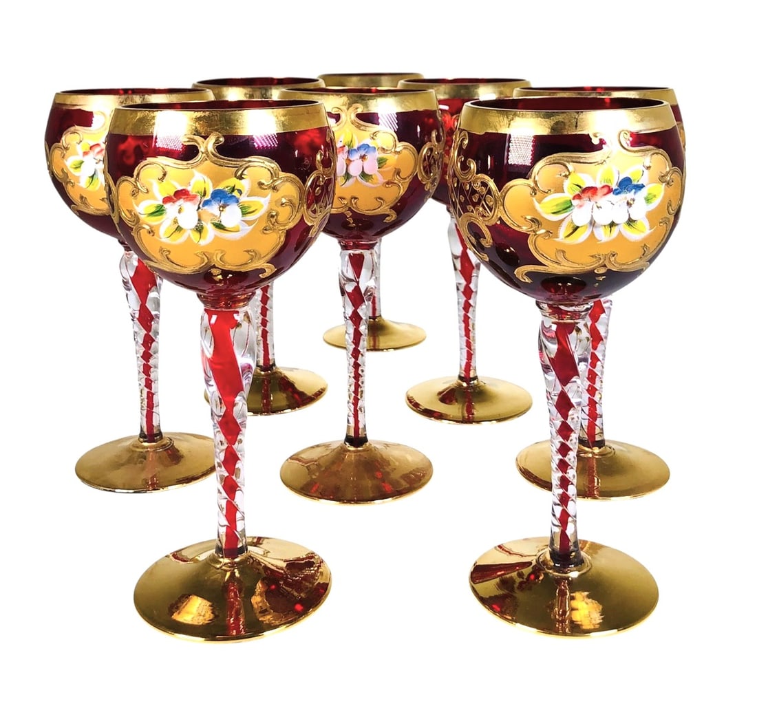 Venetian Murano Wine Goblets (8), Circa 1980: Set of eight (8) vintage ruby red Murano-glass wine goblets, with twisted stems and extensive 24KT gold accents and enamel flowers. Excellent condition. Dimensions: H. 7 inches Dia. 2 3/4 inches